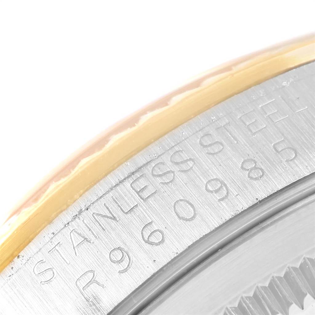 This image shows a close-up of the stainless steel and gold bezel of a Rolex Datejust 16233 Men's Steel and Gold (two tone) Beige Dial 16233 Men's Steel and Gold (two tone) Beige Dial watch, including part of the engraved serial number.