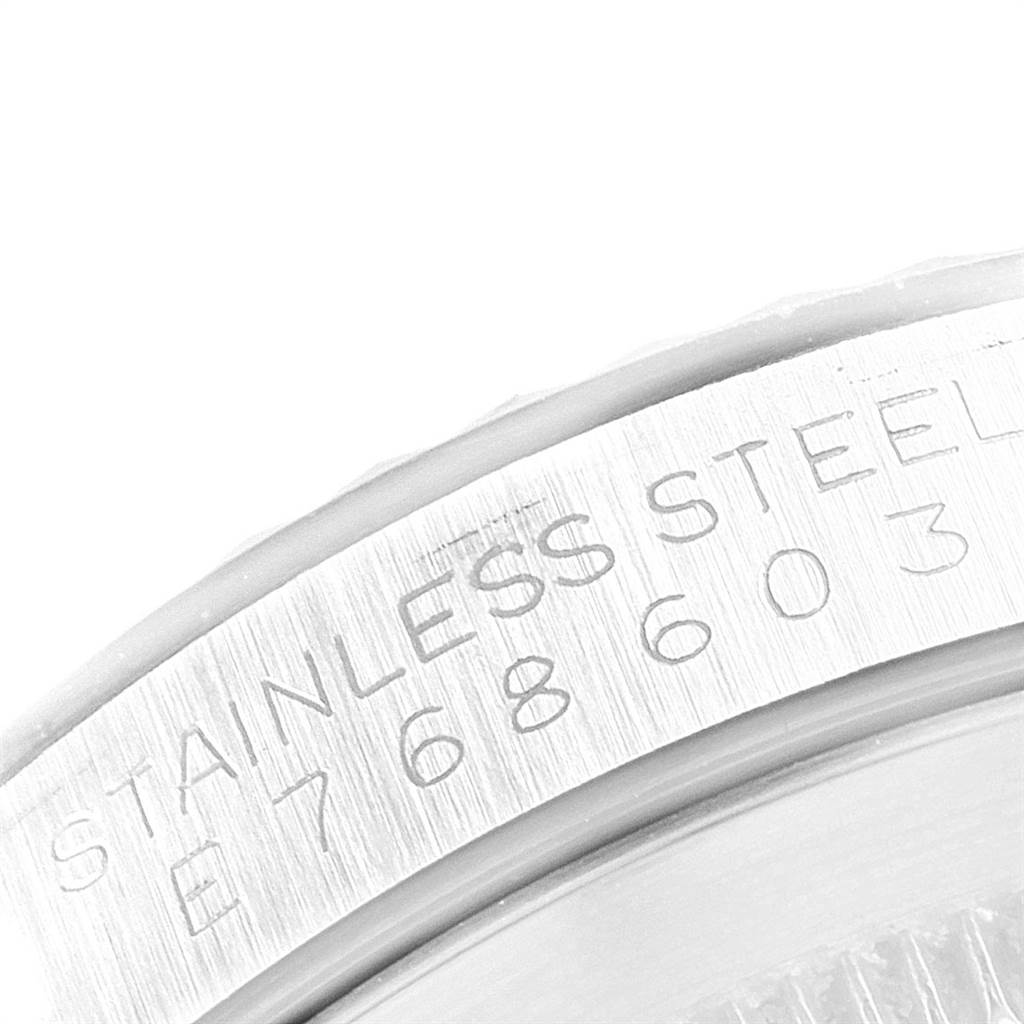 This is a close-up angle of the side of the case of a Rolex Datejust 16234 Men's Stainless Steel Silver Dial 16234 Men's Stainless Steel Silver Dial model, showing the stainless steel engraving and serial number.