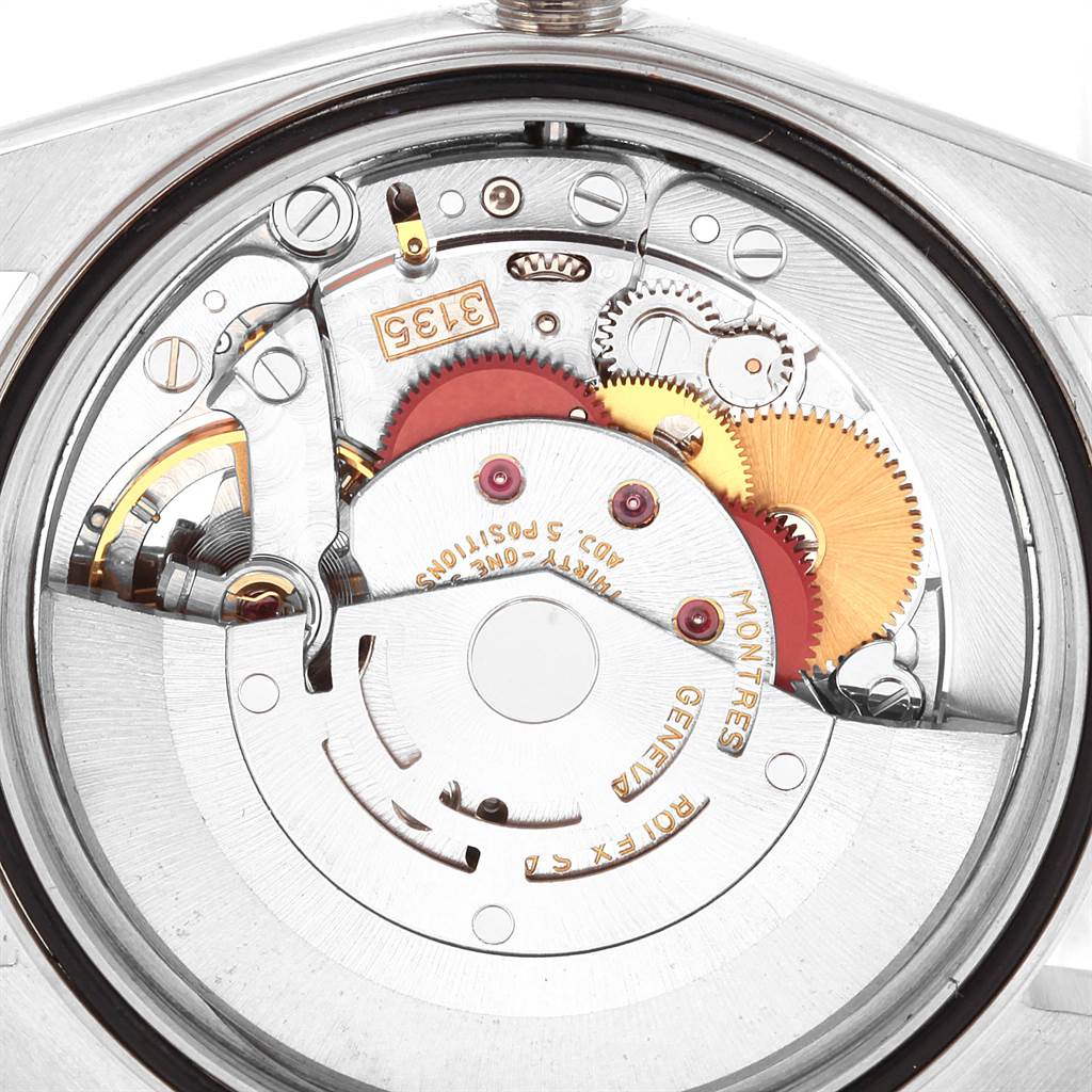 The image shows a close-up of the internal mechanism of a Rolex Datejust 16234 Men's Stainless Steel Silver Dial 16234 Men's Stainless Steel Silver Dial watch, highlighting the gears and inscriptions.