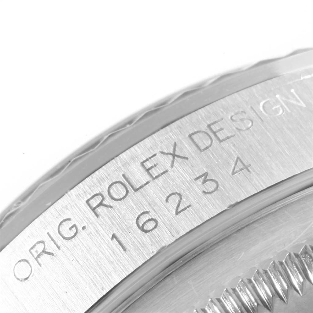 The image shows a close-up of the engraved bezel edge of a Rolex Datejust 16234 Men's Stainless Steel Silver Dial 16234 Men's Stainless Steel Silver Dial watch.