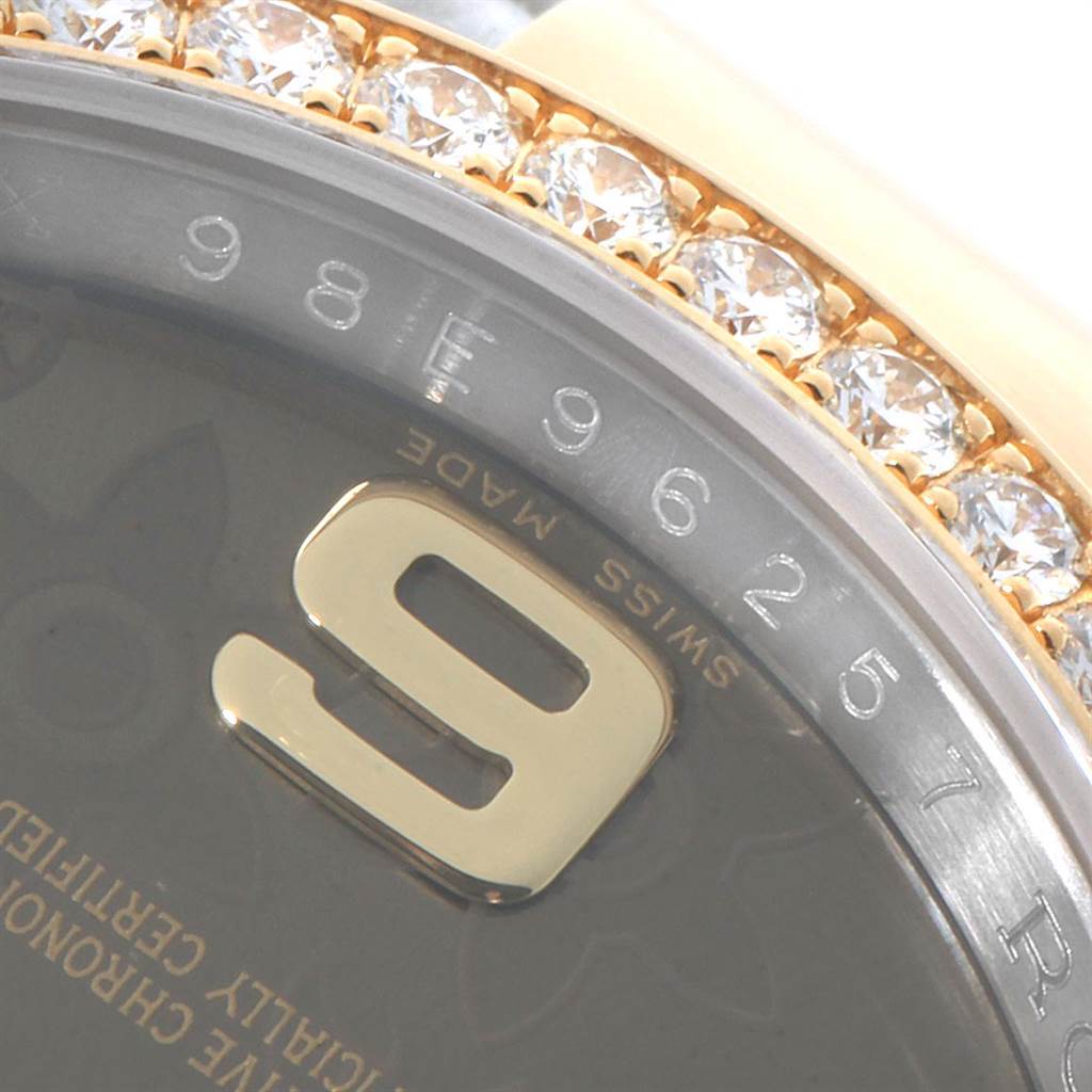 The image shows a close-up of the bezel and dial of a Rolex Datejust 116243 Women's Steel and Gold (two tone) Brown Dial 116243 Women's Steel and Gold (two tone) Brown Dial watch, highlighting a diamond-set bezel and part of the numeral '9'.