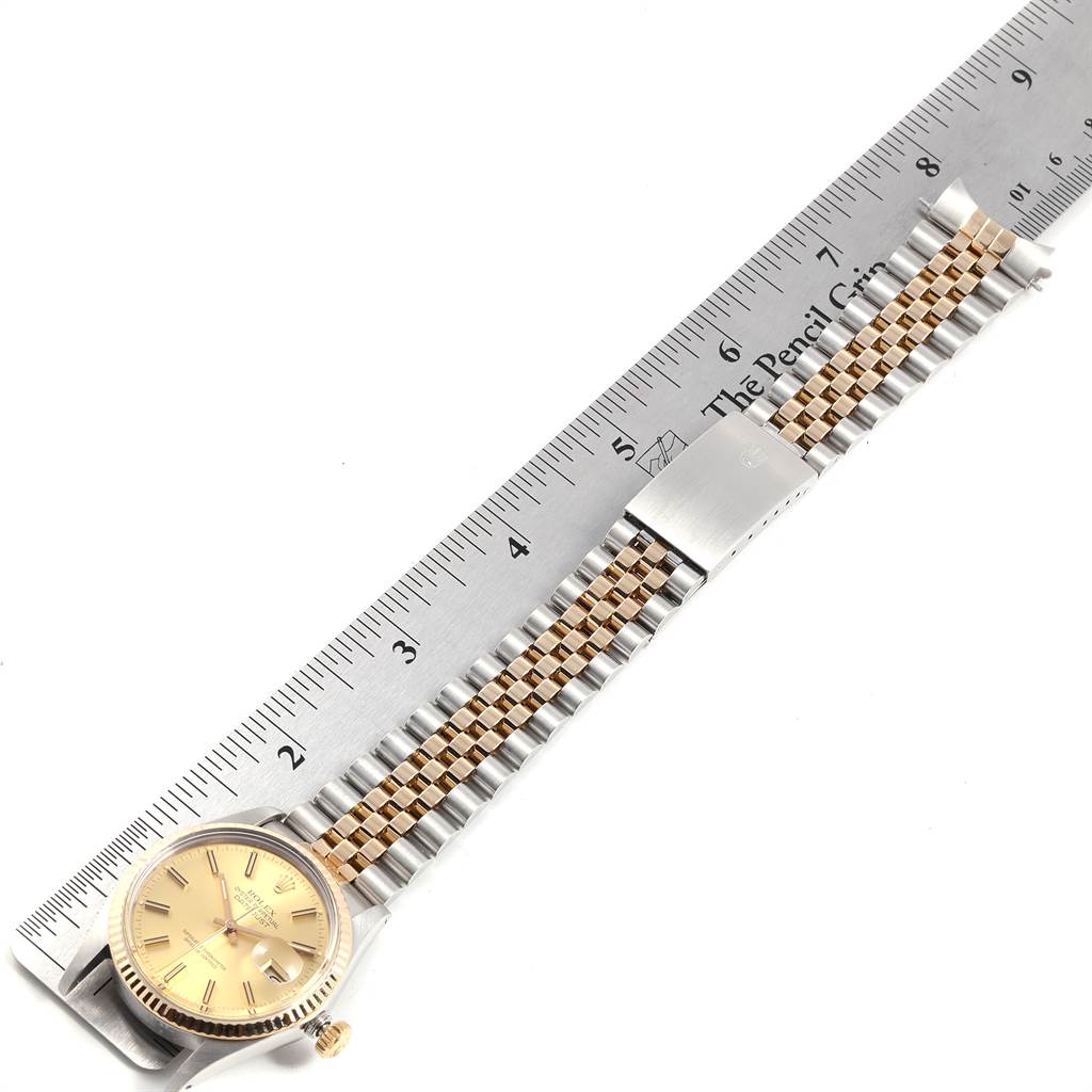 The image shows a Rolex Datejust 16013 Men's Steel and Gold (two tone) Champagne Dial 16013 Men's Steel and Gold (two tone) Champagne Dial watch laid flat with its face, bezel, and bracelet visible next to a ruler.