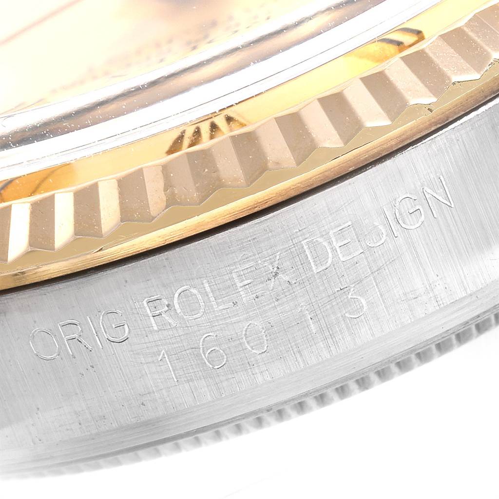 The image shows a close-up of the side of the bezel and case of a Rolex Datejust 16013 Men's Steel and Gold (two tone) Champagne Dial 16013 Men's Steel and Gold (two tone) Champagne Dial watch, with part of the serial number visible.