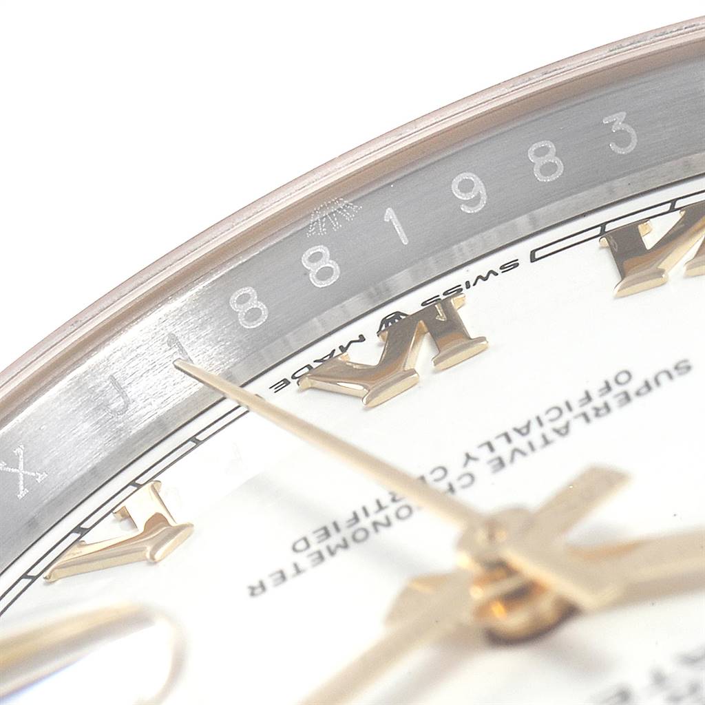 This image shows a close-up angle of the Rolex Datejust 126233 Men's Steel and Gold (two tone) White Dial 126233 Men's Steel and Gold (two tone) White Dial watch, featuring its hands, Roman numerals, and part of the rehaut.