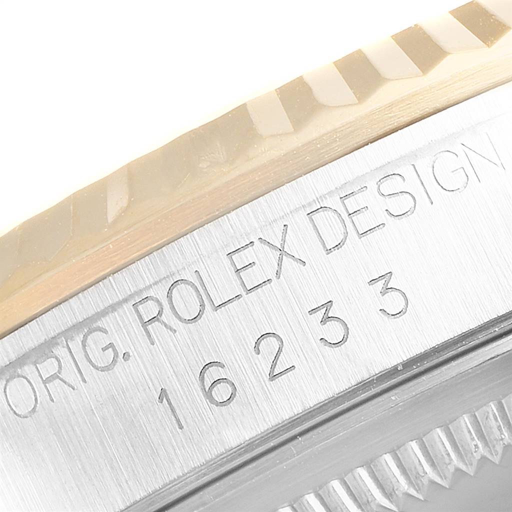 This close-up image shows the engraved text and fluted bezel of a Rolex Datejust 16233 Men's Steel and Gold (two tone) Champagne Dial 16233 Men's Steel and Gold (two tone) Champagne Dial watch.