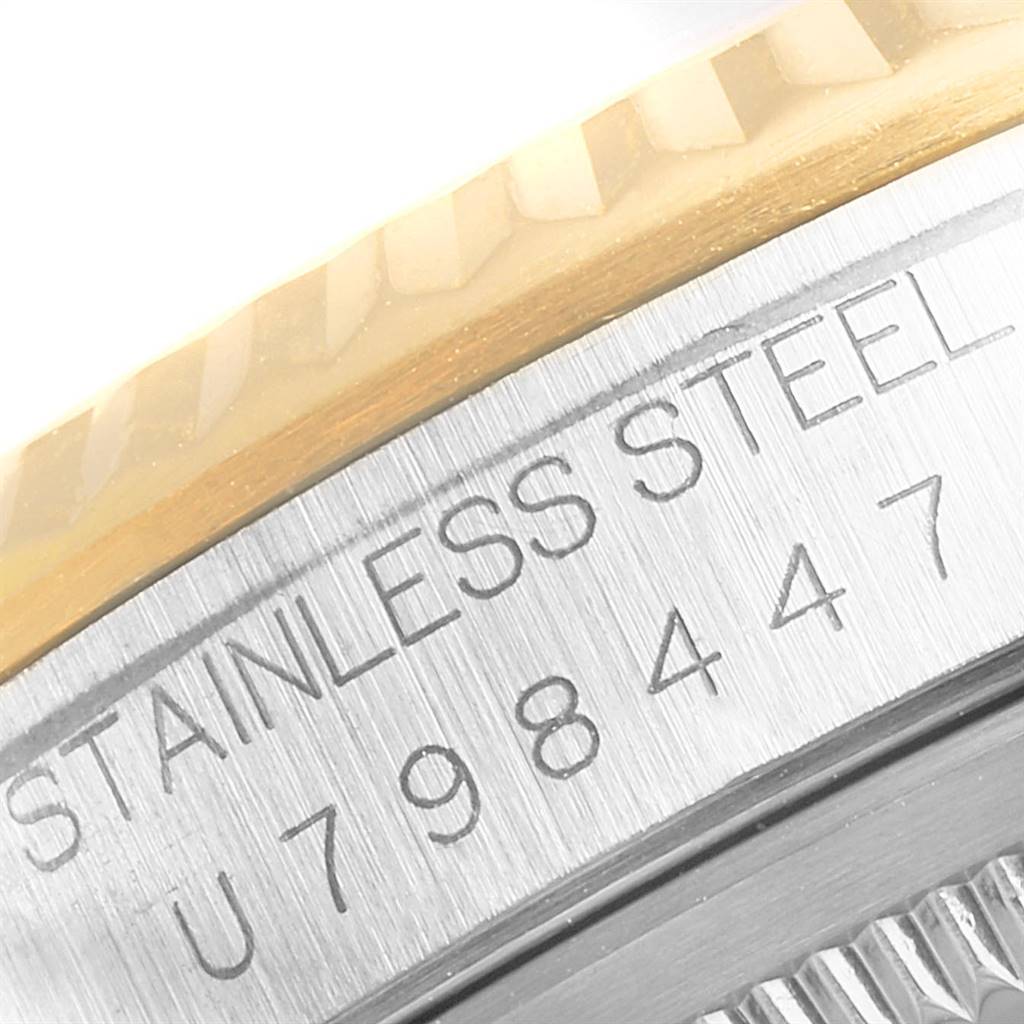 The image shows a close-up of the serial number and "STAINLESS STEEL" engraving on the case of a Rolex Datejust 16233 Men's Steel and Gold (two tone) Champagne Dial 16233 Men's Steel and Gold (two tone) Champagne Dial watch.