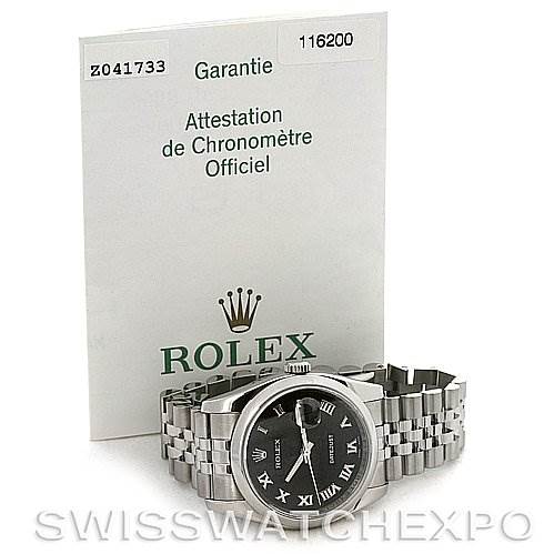 The image shows a Rolex Datejust 116200-BKRJ Men's Stainless Steel Black Dial 116200-BKRJ Men's Stainless Steel Black Dial watch lying flat with paperwork, including a warranty document, displayed behind it.