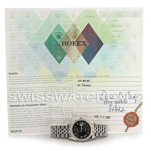 The image shows a Rolex Datejust 116200-BKRJ Men's Stainless Steel Black Dial 116200-BKRJ Men's Stainless Steel Black Dial watch placed in front of its warranty and authenticity certificate viewed from the front.