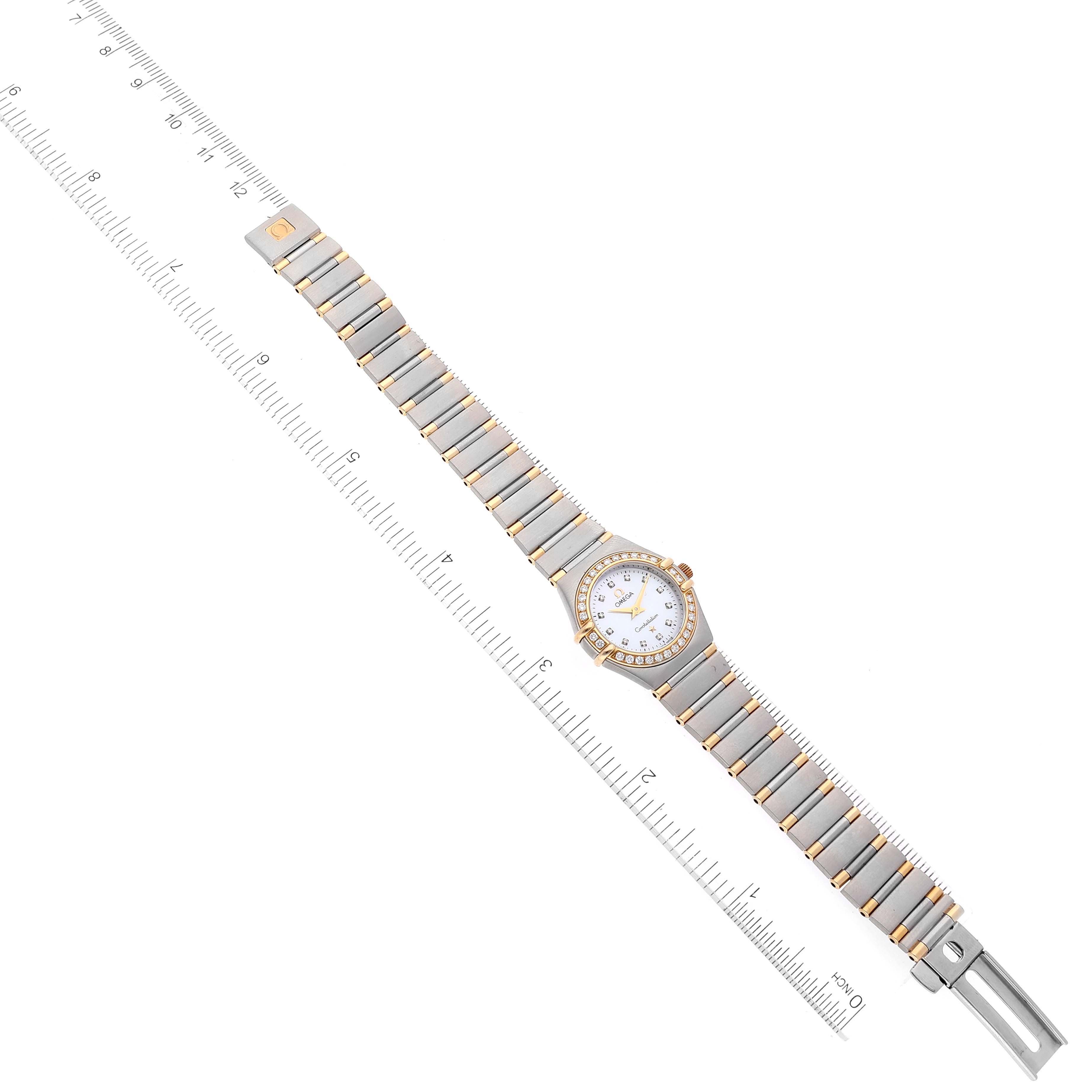 The Omega 1367.75.00 Women's Steel and Gold (two tone) Mother of Pearl Dial 1367.75.00 Women's Steel and Gold (two tone) Mother of Pearl Dial Constellation 1367.75.00 watch is shown fully extended from a top view with a ruler for scale.