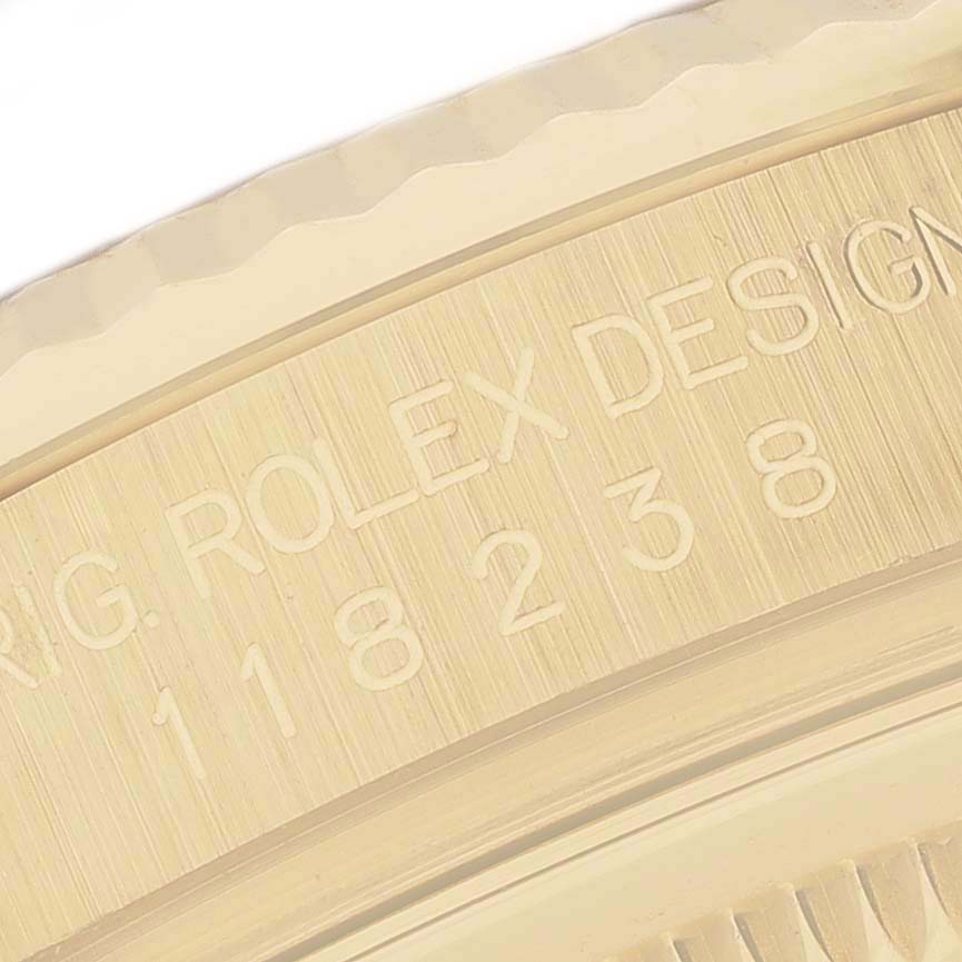 The image shows a close-up of the engraving on the Rolex President 118238 Men's Yellow Gold Green Dial 118238 Men's Yellow Gold Green Dial watch's case side, highlighting the model number and brand.