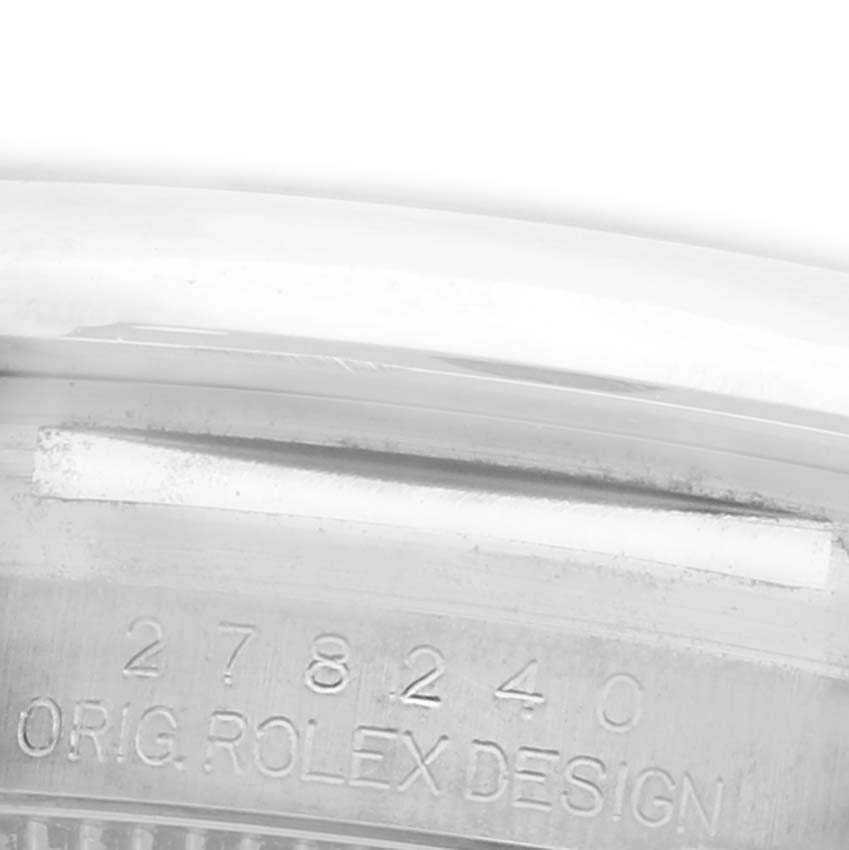 The image shows a close-up of the engraving on the case of a Rolex Datejust watch.