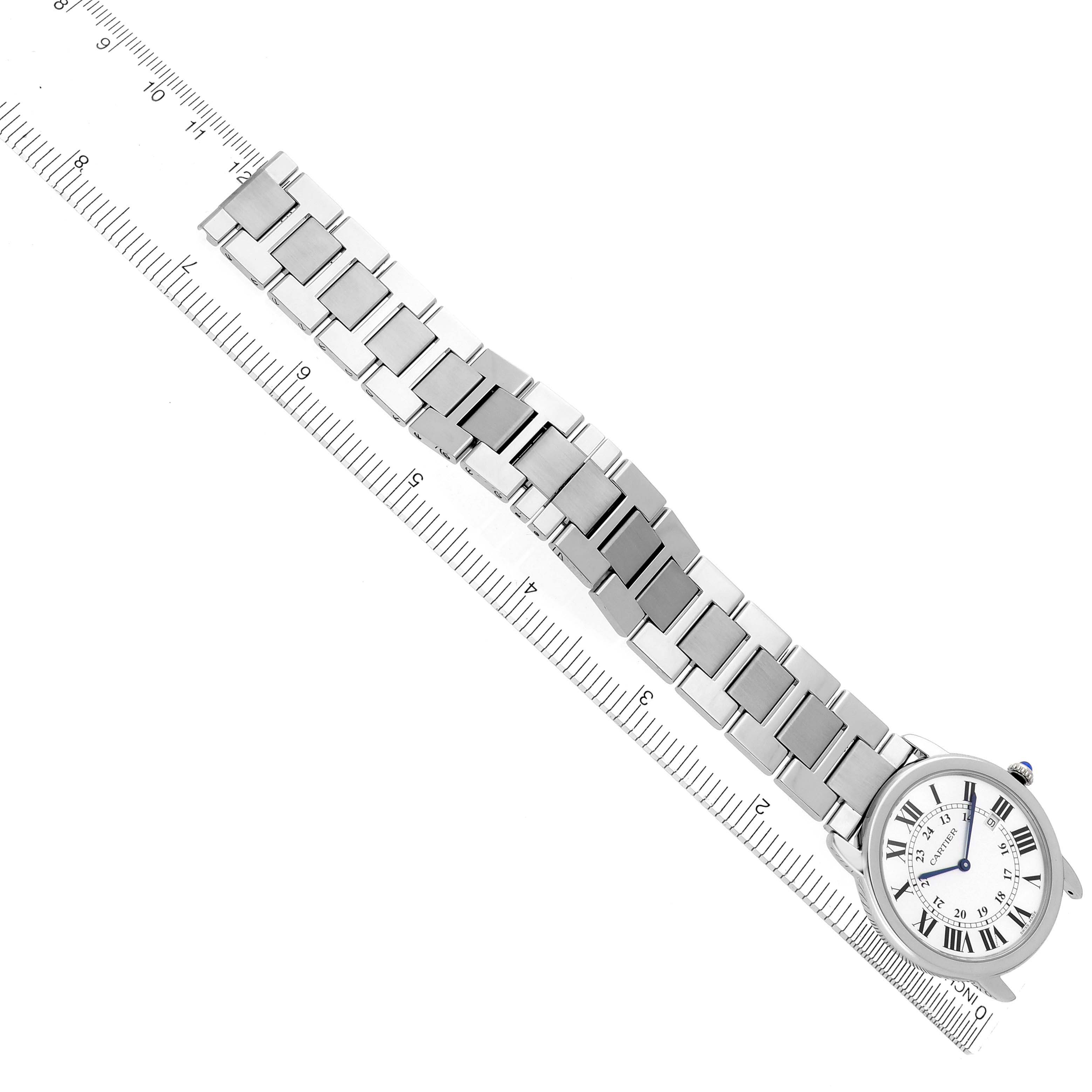 The Cartier Ronde W6701005 Men's Stainless Steel Silver Dial W6701005 Men's Stainless Steel Silver Dial watch is shown from an overhead angle, displaying the face and metal bracelet with a ruler for scale.
