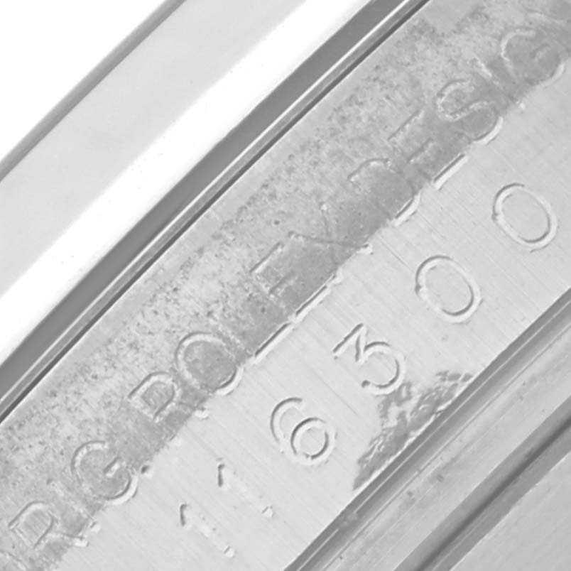 The image shows an angled view of the Rolex Datejust 41 116300 Men's Stainless Steel Silver Dial 116300 Men's Stainless Steel Silver Dial's inner bezel with engraved text and numbers.