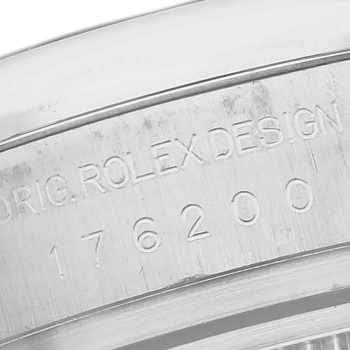 The image shows a close-up of the serial number engraving on the casing of a Rolex Oyster Perpetual 176200 Women's Stainless Steel Silver Dial 176200 Women's Stainless Steel Silver Dial watch.
