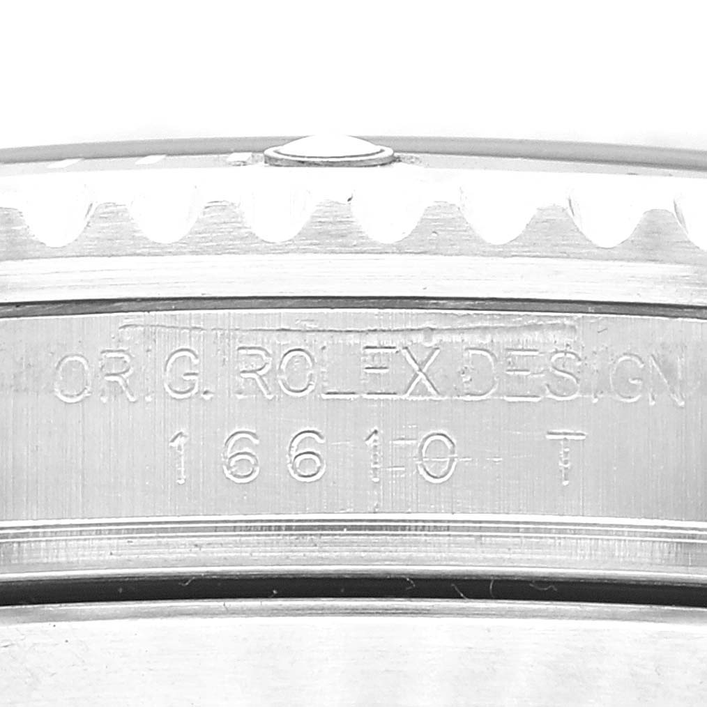 This image shows a close-up of the side case and bezel of a Rolex Submariner 16610 Men's Stainless Steel Black Dial 16610 Men's Stainless Steel Black Dial watch, specifically displaying its engraved reference number.