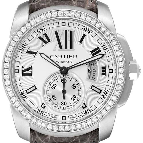 The image shows a front view of a Calibre de Cartier watch by Cartier, featuring a diamond-studded bezel and a leather strap.