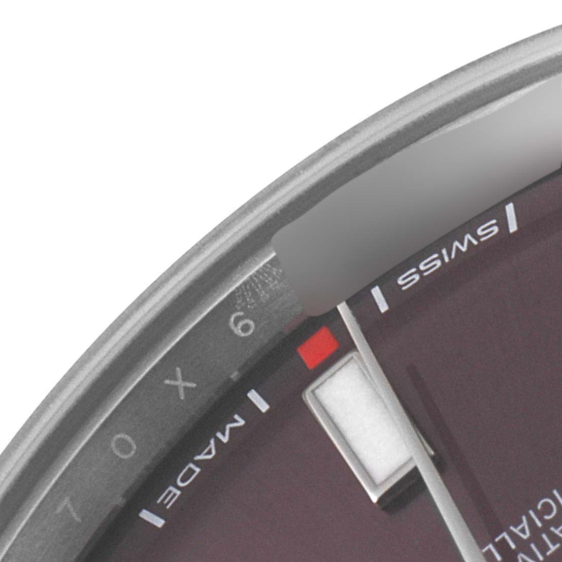 This is a close-up of the dial of a Rolex Oyster Perpetual 114300 Men's Stainless Steel Burgundy Dial 114300 Men's Stainless Steel Burgundy Dial watch, showing part of the hour markers and the "Swiss Made" text.