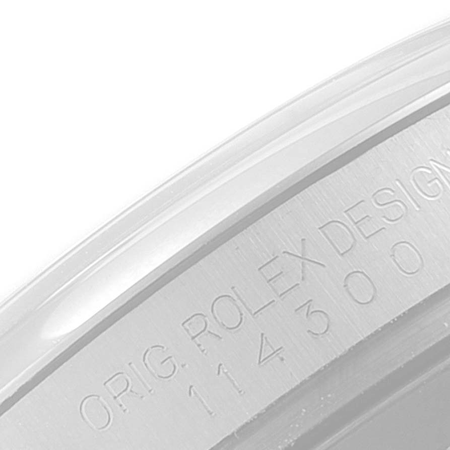 This image shows a close-up view of the engraved model number on the side of the Rolex Oyster Perpetual 114300 Men's Stainless Steel Burgundy Dial 114300 Men's Stainless Steel Burgundy Dial case.