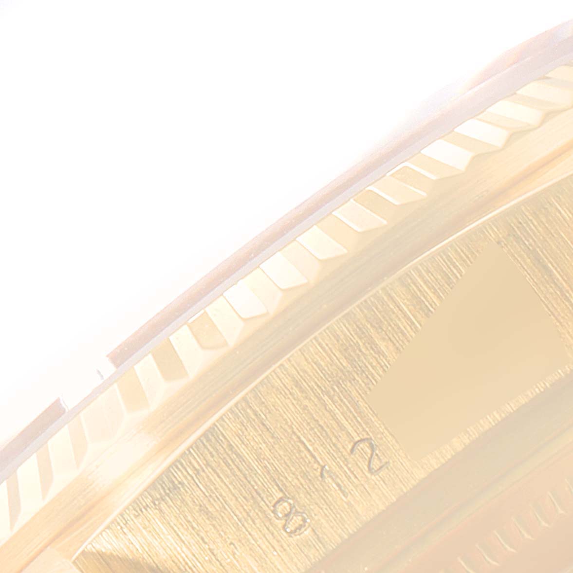 This image shows a close-up of the bezel and partial dial of the Rolex President 18038 Men's Yellow Gold Champagne Dial 18038 Men's Yellow Gold Champagne Dial model watch.