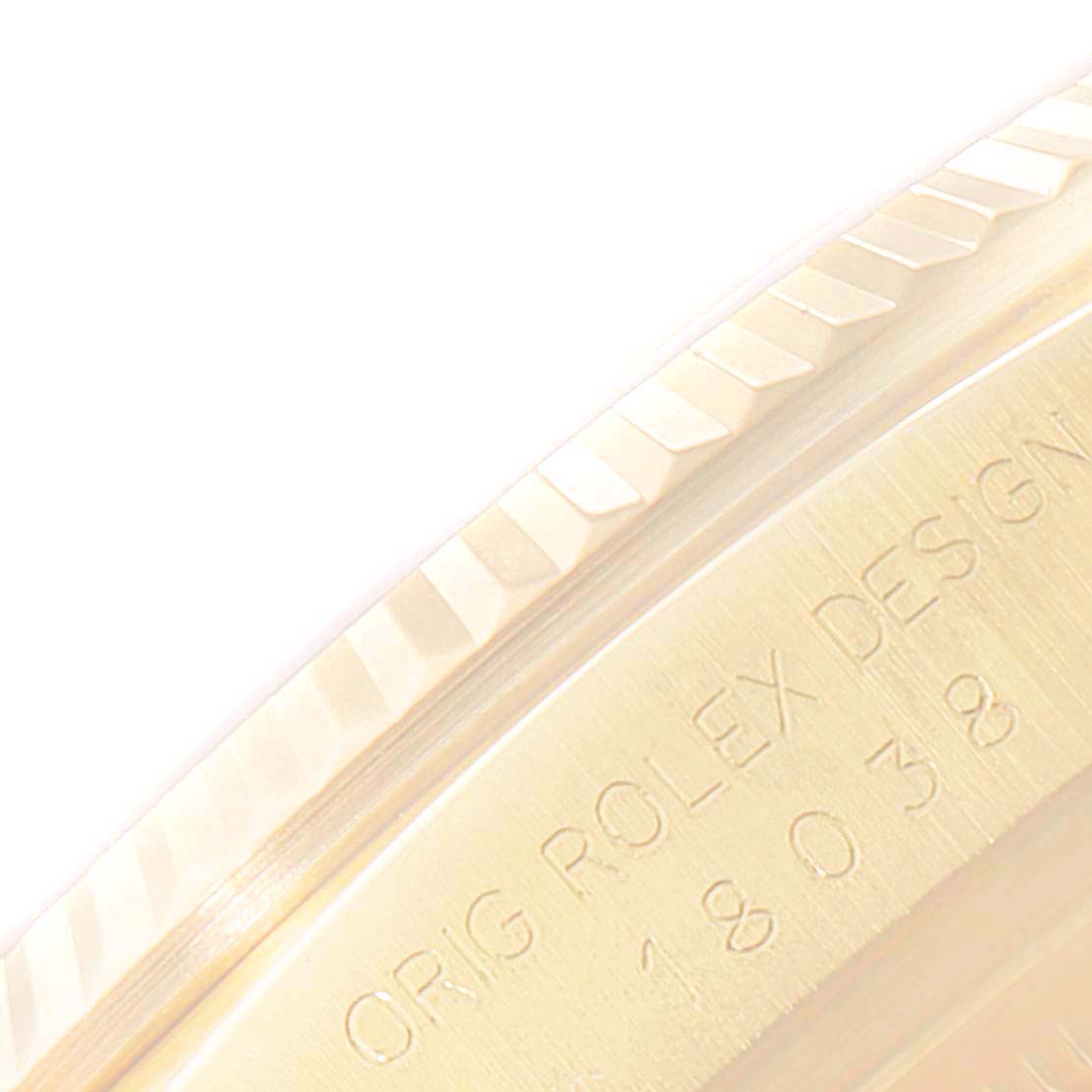 This close-up image shows the engraved case back and fluted bezel of a Rolex President 18038 Men's Yellow Gold Champagne Dial 18038 Men's Yellow Gold Champagne Dial model watch.