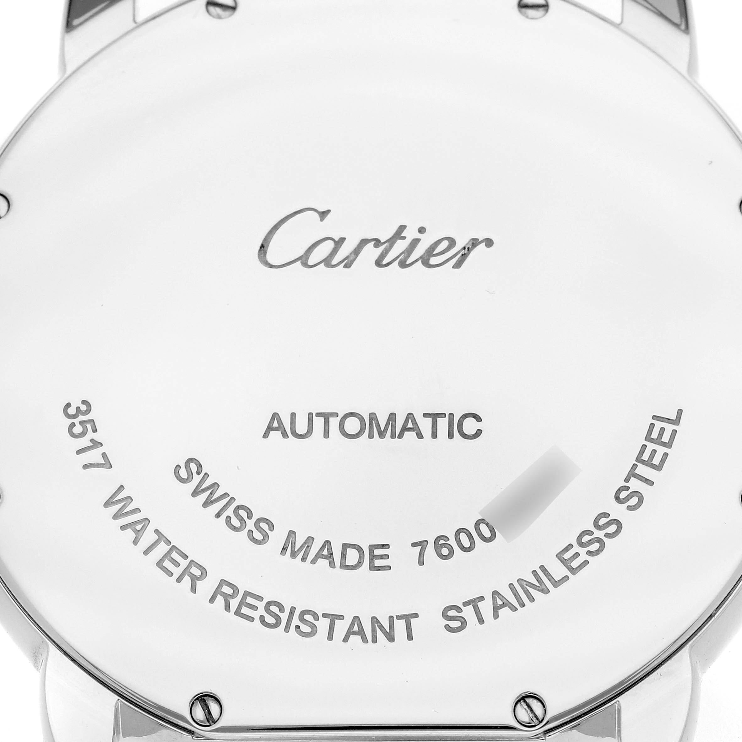 The image shows the back case of a Cartier Ronde W6701011 Men's Stainless Steel Silver Dial W6701011 Men's Stainless Steel Silver Dial watch, displaying engravings and screws.