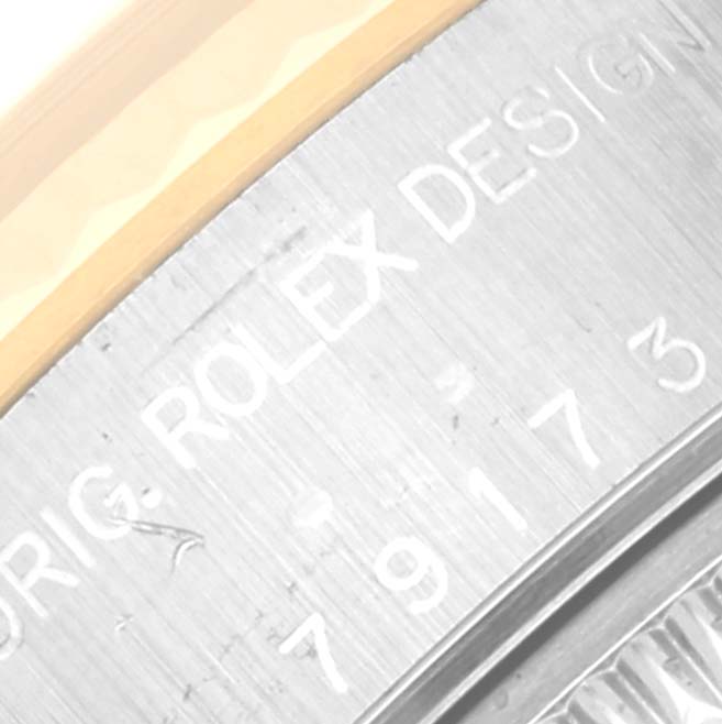 The image shows a close-up of the engraved case side of a Rolex Datejust 79173 Women's Steel and Gold (two tone) Beige Dial 79173 Women's Steel and Gold (two tone) Beige Dial watch, featuring the model and design inscriptions.