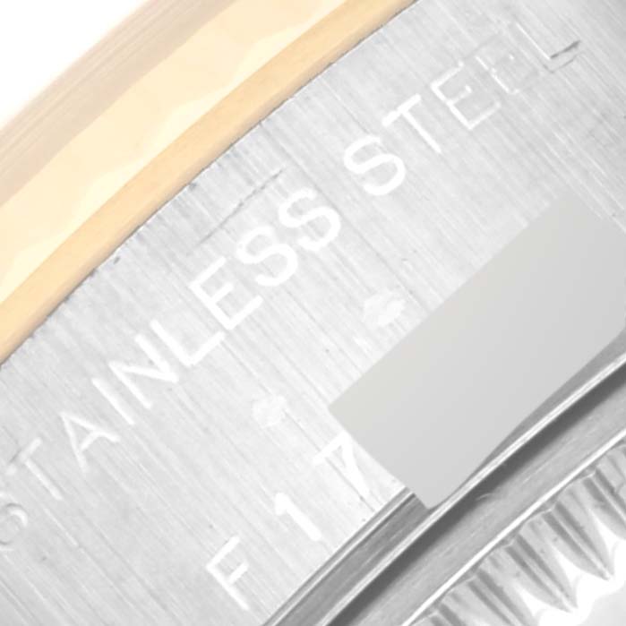 This image shows a close-up of the side of a Rolex Datejust 79173 Women's Steel and Gold (two tone) Beige Dial 79173 Women's Steel and Gold (two tone) Beige Dial watch, highlighting the "STAINLESS STEEL" inscription and a part of the band.