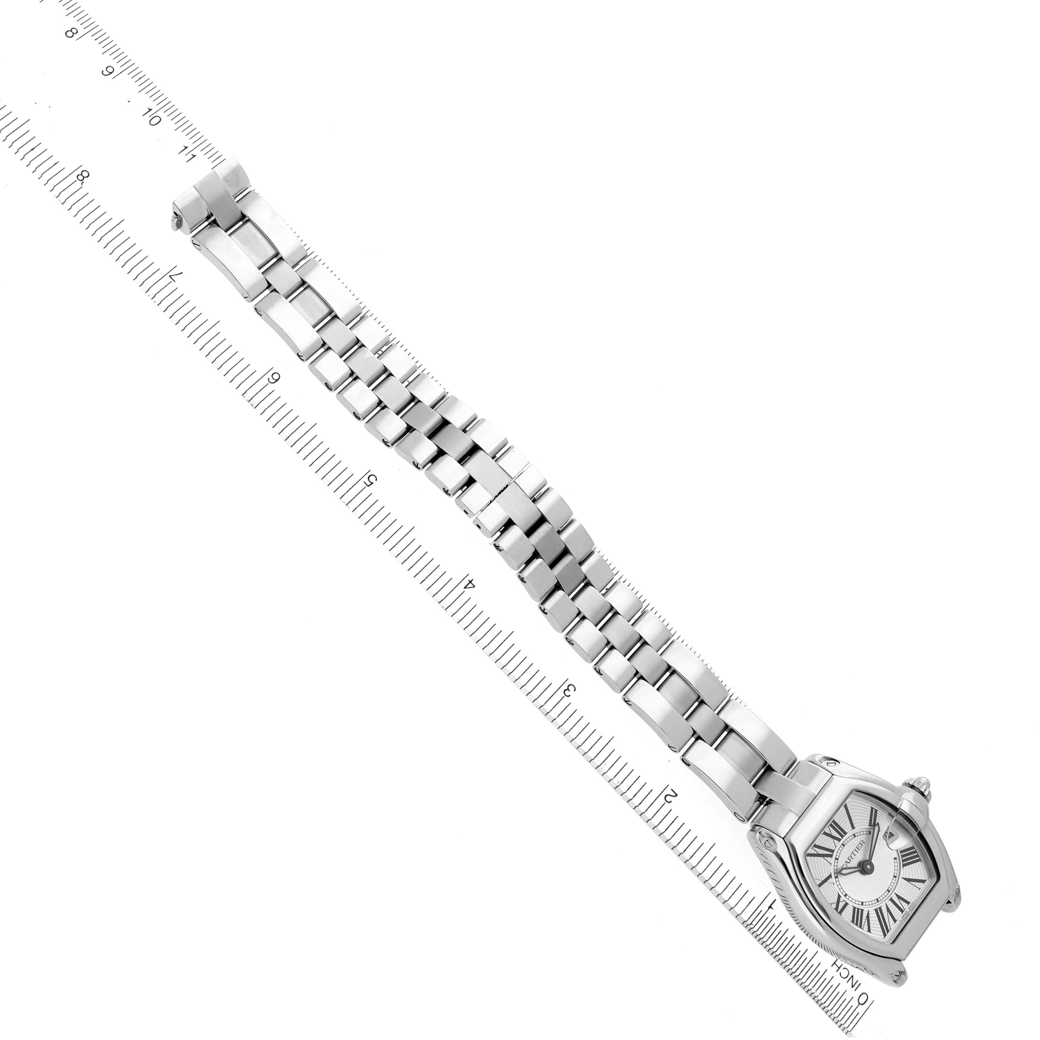 The Cartier Roadster W62016V3 Women's Stainless Steel Silver Dial W62016V3 Women's Stainless Steel Silver Dial watch is shown from a top view, displaying its dial, bracelet, and part of a ruler for scale.
