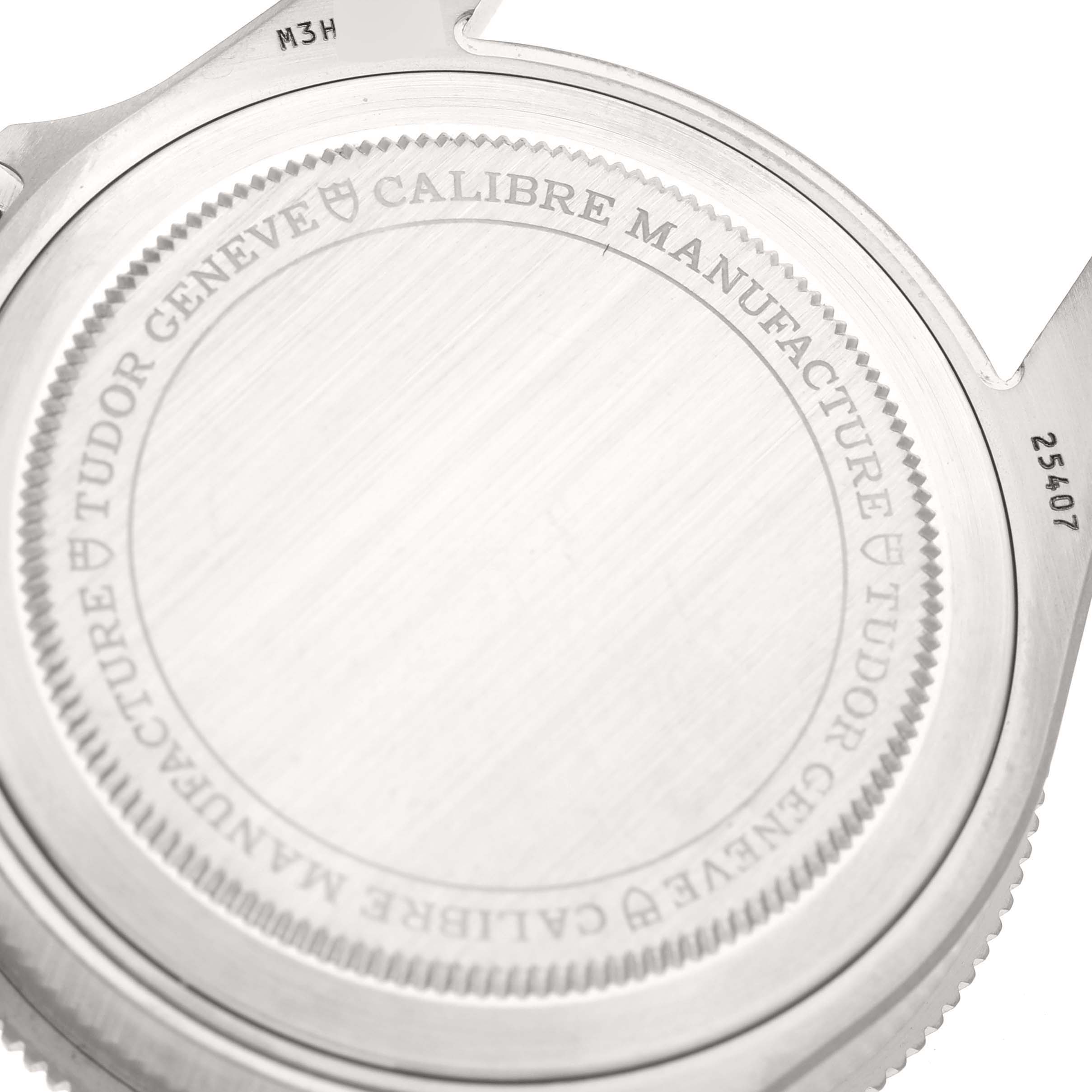 The image shows the back case of a Tudor Pelagos 25407N-0001 Men's Titanium Black Dial 25407N-0001 Men's Titanium Black Dial watch, highlighting the engraved details and serial numbers.