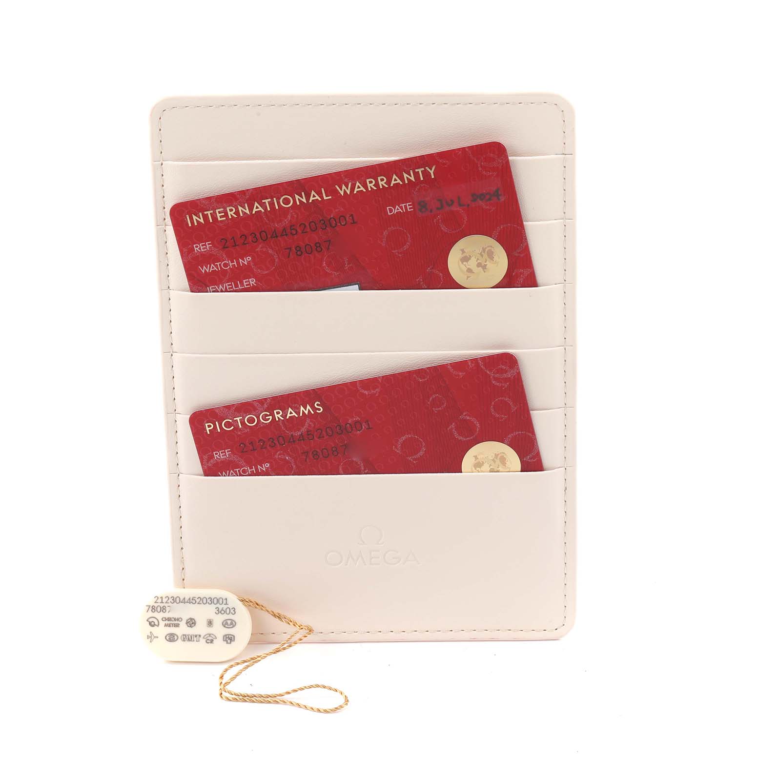 The image shows Omega Seamaster 212.30.44.52.03.001 Men's Stainless Steel Blue Dial 212.30.44.52.03.001 Men's Stainless Steel Blue Dial's warranty and pictogram cards in a cream cardholder with a tag attached.