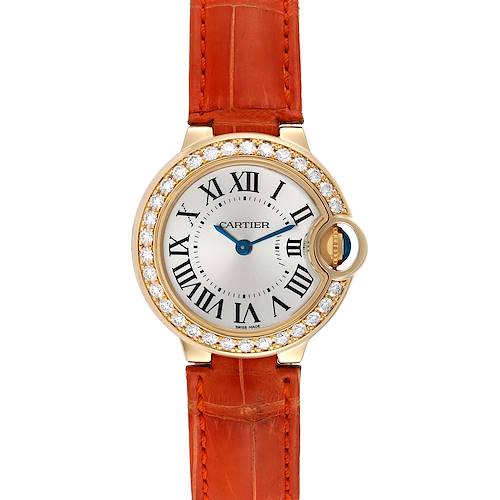 The image shows a front view of a Ballon Bleu de Cartier watch with a diamond bezel and an orange leather strap.