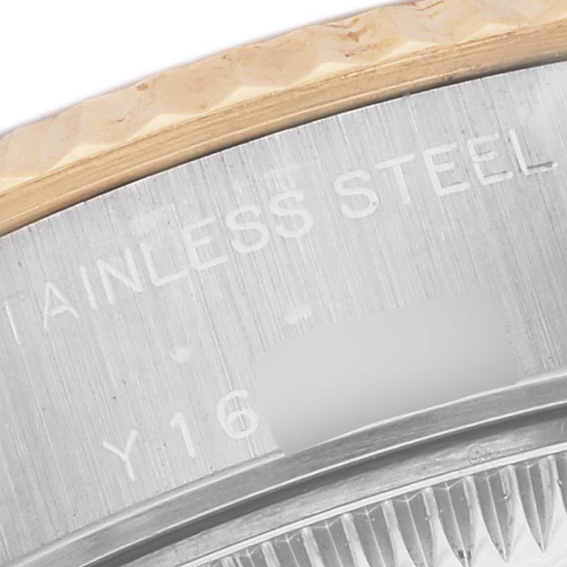The image shows a close-up of the bezel and case edge of a Rolex Datejust 79173 Women's Steel and Gold (two tone) Beige Dial 79173 Women's Steel and Gold (two tone) Beige Dial watch, highlighting the engraved text.