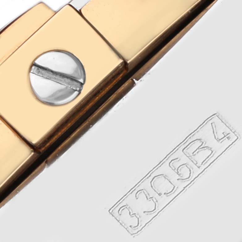 This close-up shows part of the bracelet clasp with a screw detail and engraving on a Breitling Chronomat C156A19PAC Men's Steel and Gold (two tone) Silver Dial C156A19PAC Men's Steel and Gold (two tone) Silver Dial watch.