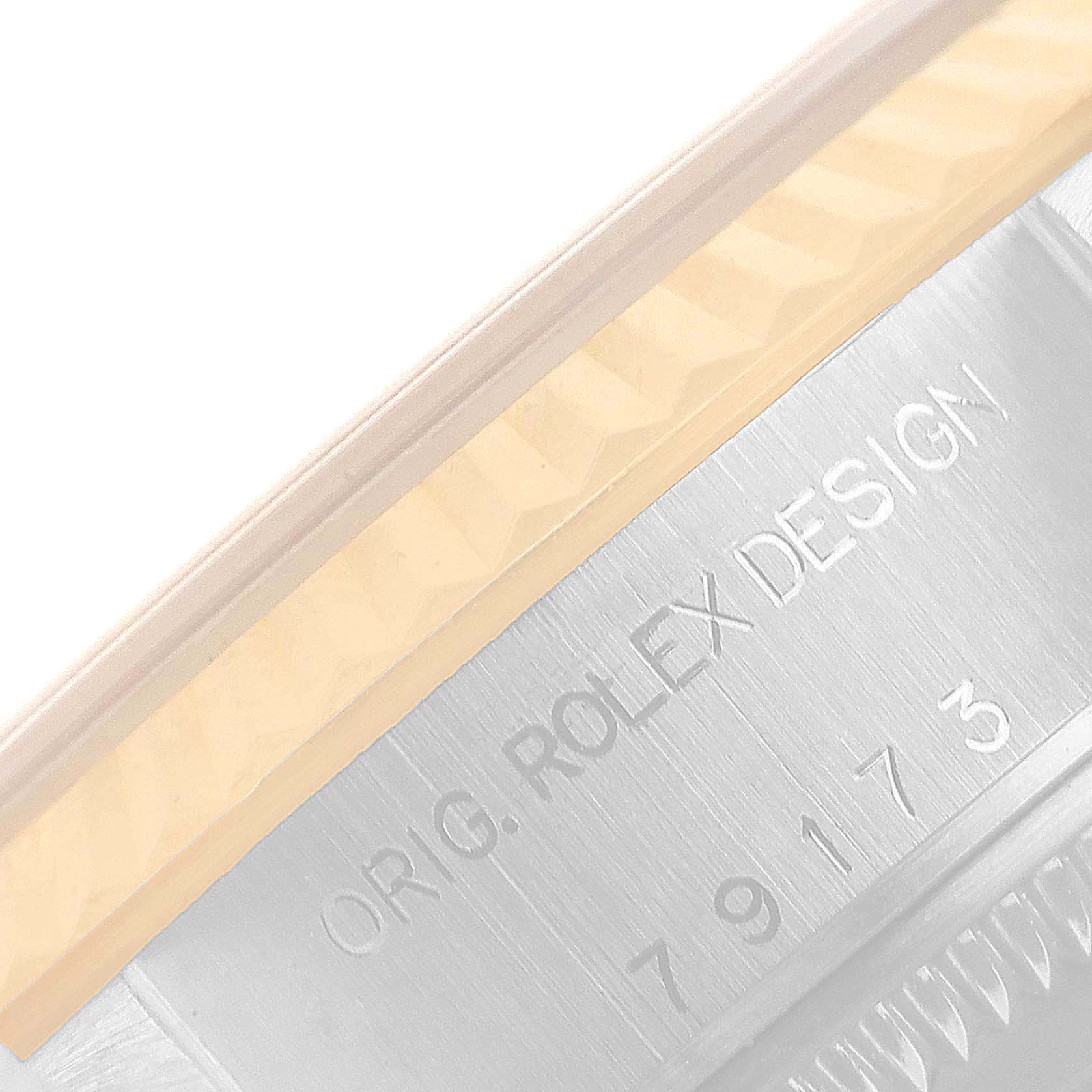 This image shows a close-up of the side of a Rolex Datejust 79173 Women's Steel and Gold (two tone) White Dial 79173 Women's Steel and Gold (two tone) White Dial model, highlighting the engraved "ORIG. ROLEX DESIGN" inscription.