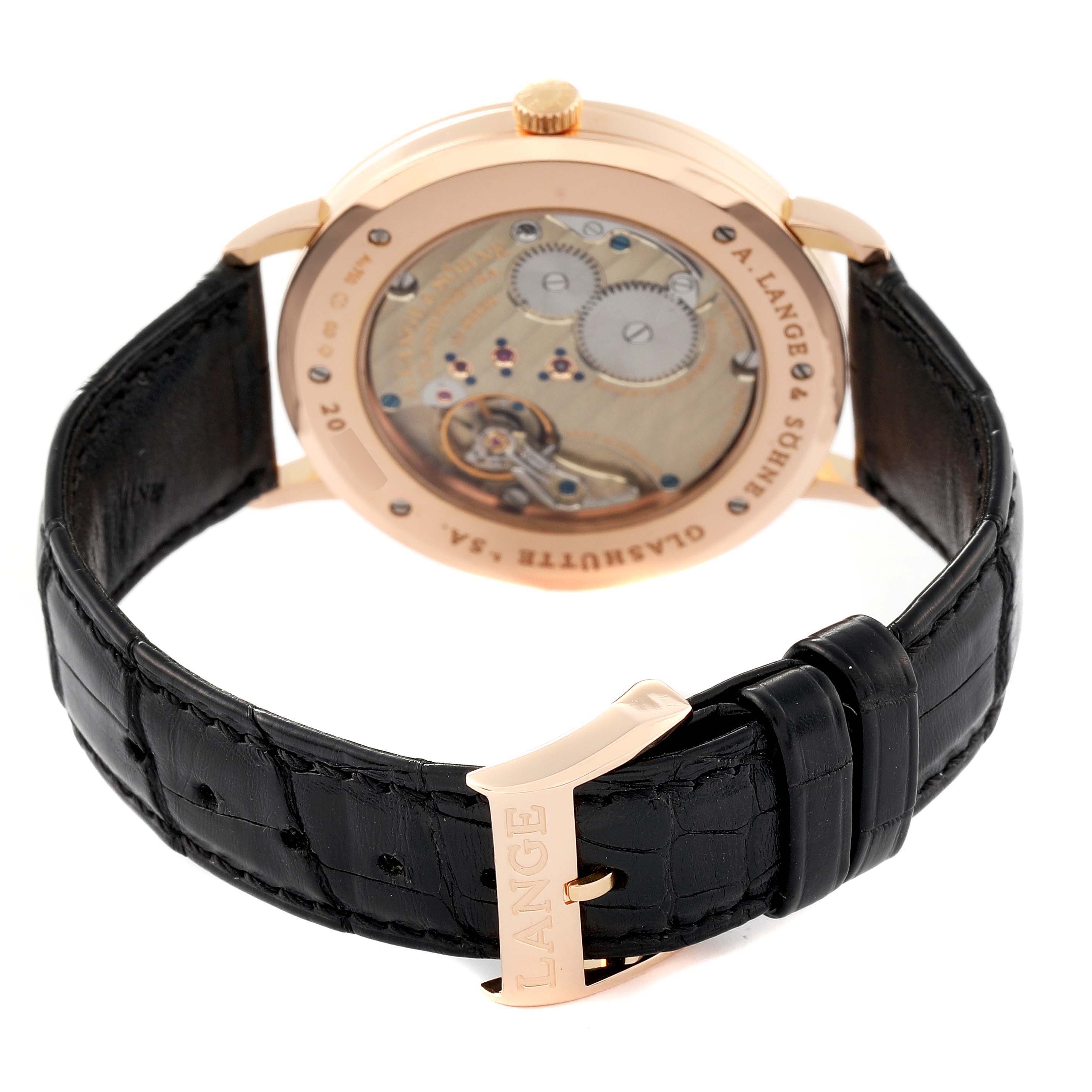 This image shows the back view of the A. Lange & Sohne Saxonia 211.032 Men's Rose Gold Silver Dial watch, displaying the movement and black leather strap.