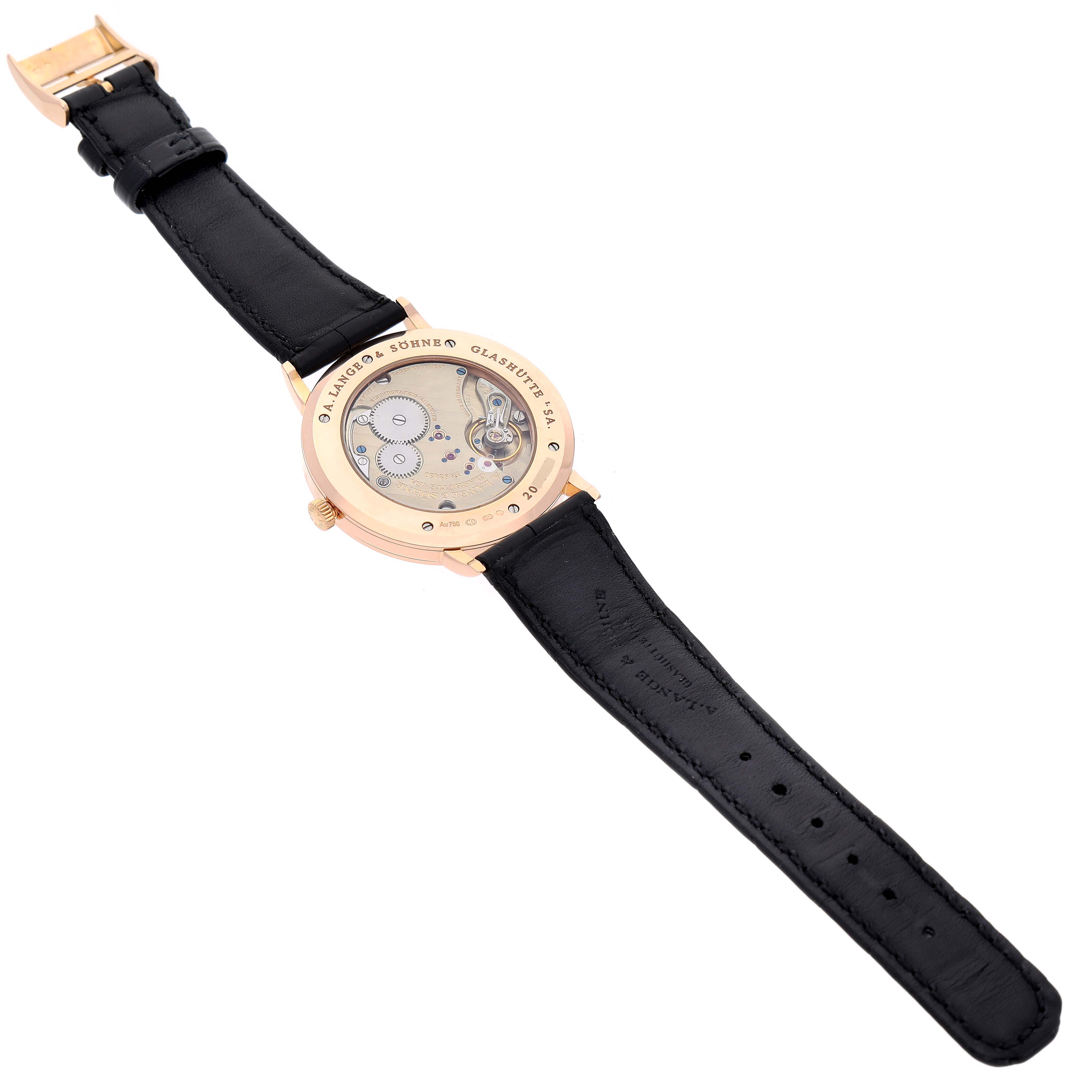 The image shows the back view of the A. Lange & Sohne Saxonia 211.032 Men's Rose Gold Silver Dial watch, displaying its movement through the transparent case back and the black leather strap.