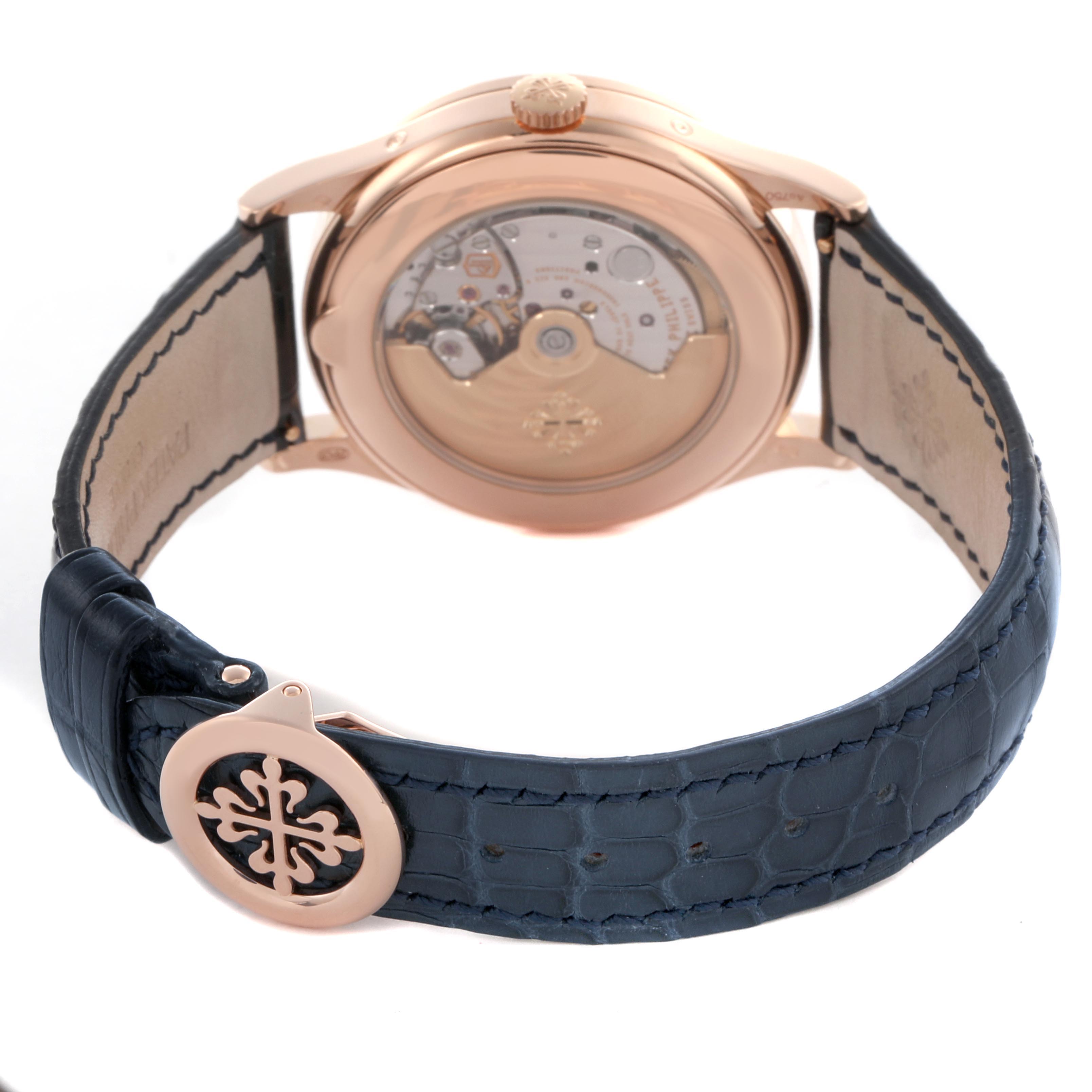 The image shows the back of a Patek Philippe Complications 5396R-014 Men's Rose Gold Blue Dial 5396R-014 Men's Rose Gold Blue Dial watch, highlighting the movement through a transparent case back and its clasp.