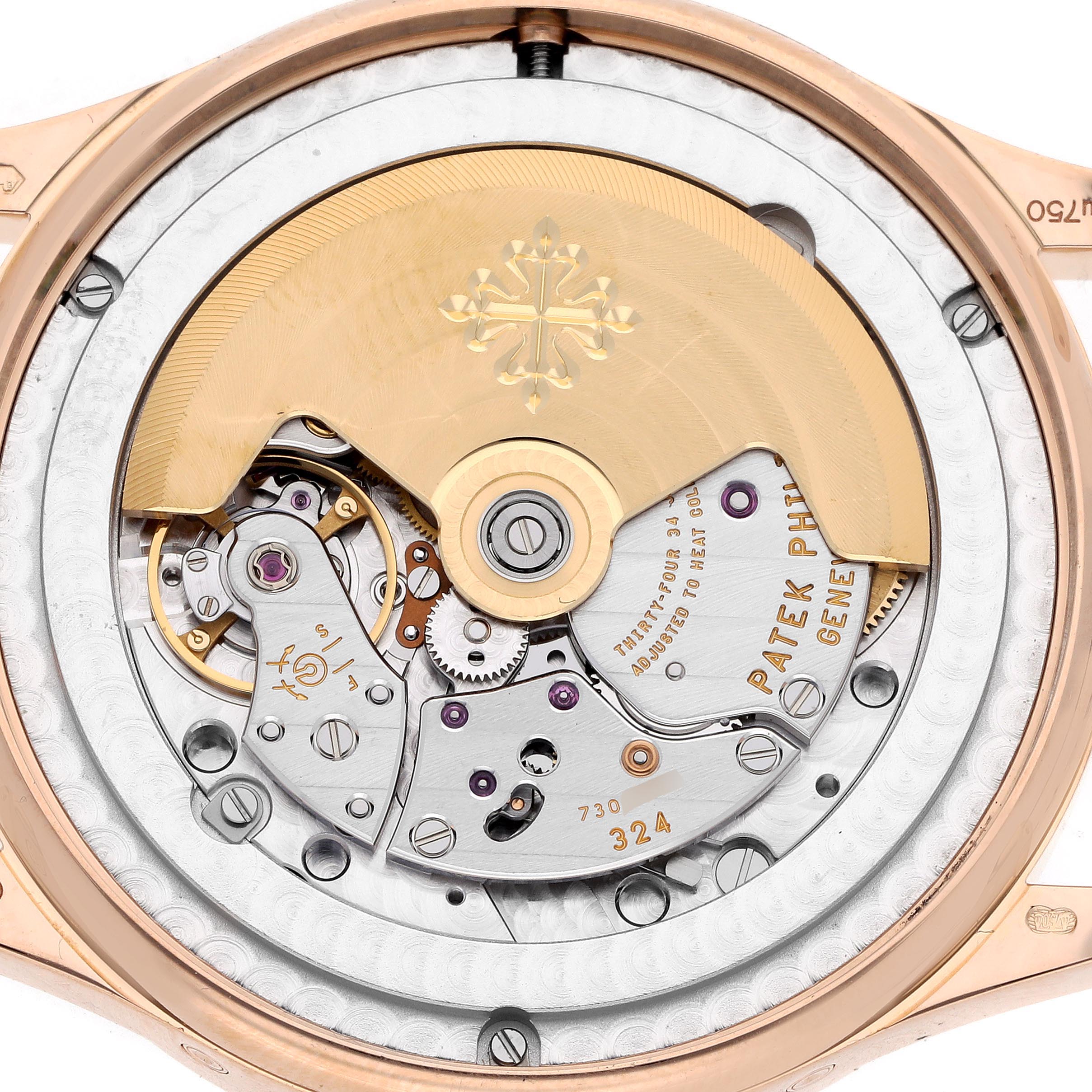 The image shows a close-up of the movement from the back angle of the Patek Philippe Complications 5396R-014 Men's Rose Gold Blue Dial 5396R-014 Men's Rose Gold Blue Dial watch, featuring its rotor and gears.
