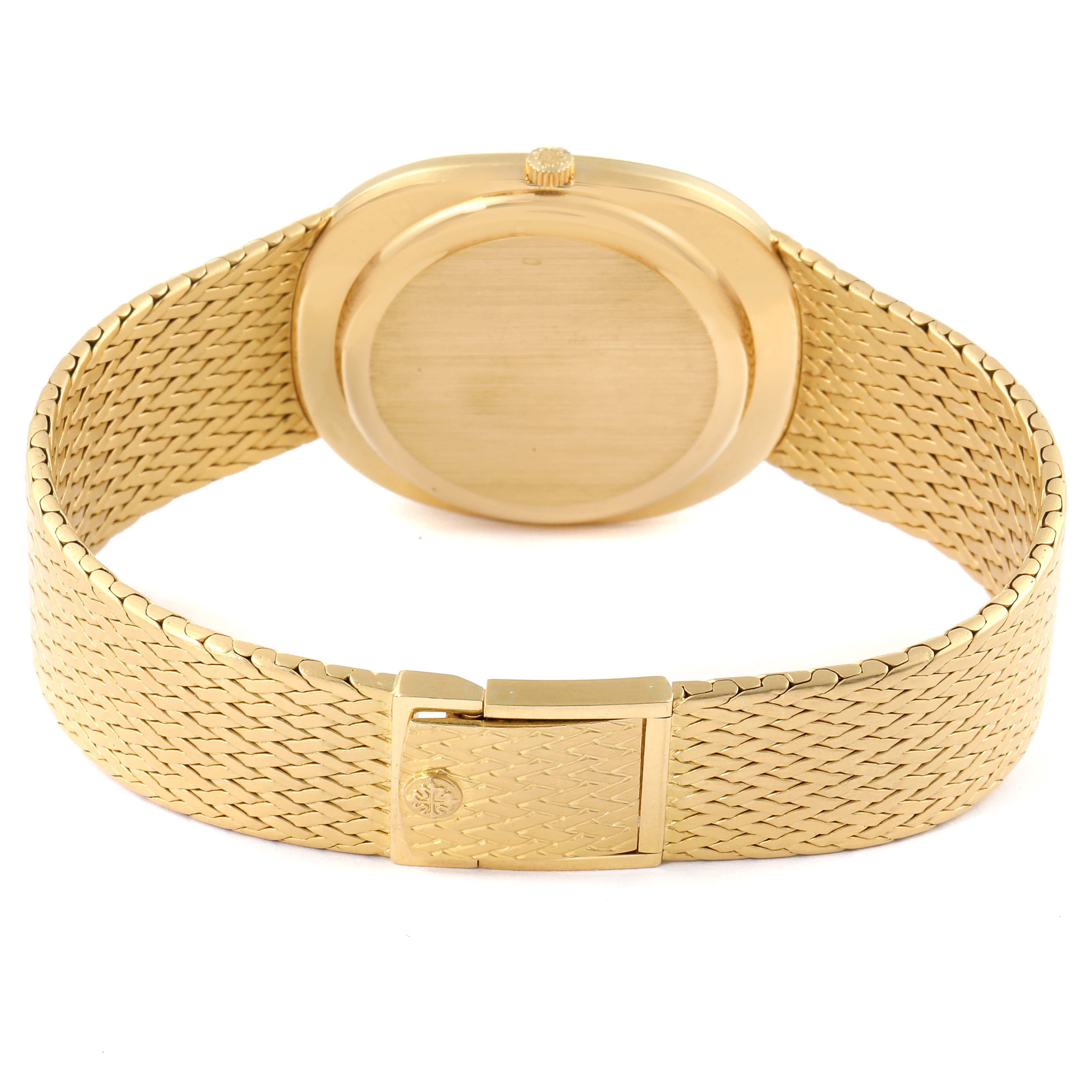 The image shows the rear view of a Patek Philippe Golden Ellipse 3605 Men's Yellow Gold Champagne Dial 3605 Men's Yellow Gold Champagne Dial watch, highlighting its gold case and woven bracelet.