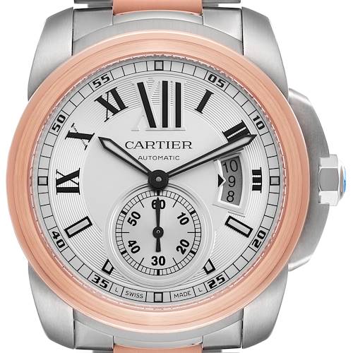 The Calibre de Cartier watch is shown from a front angle, highlighting the dial, hands, bezel, and date window.