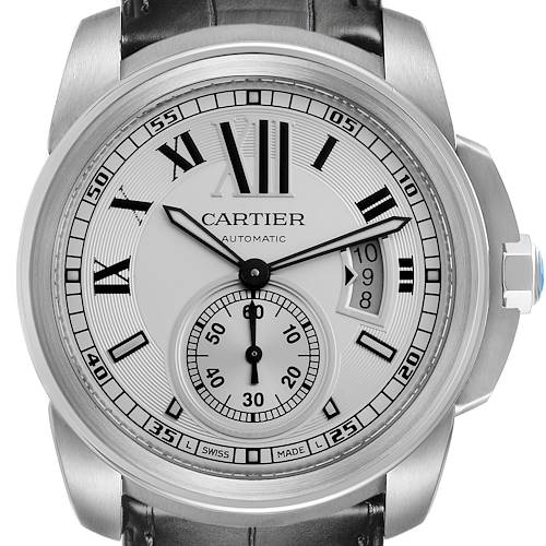 The image shows a frontal close-up of the Calibre de Cartier watch, displaying the dial, hands, and date window.