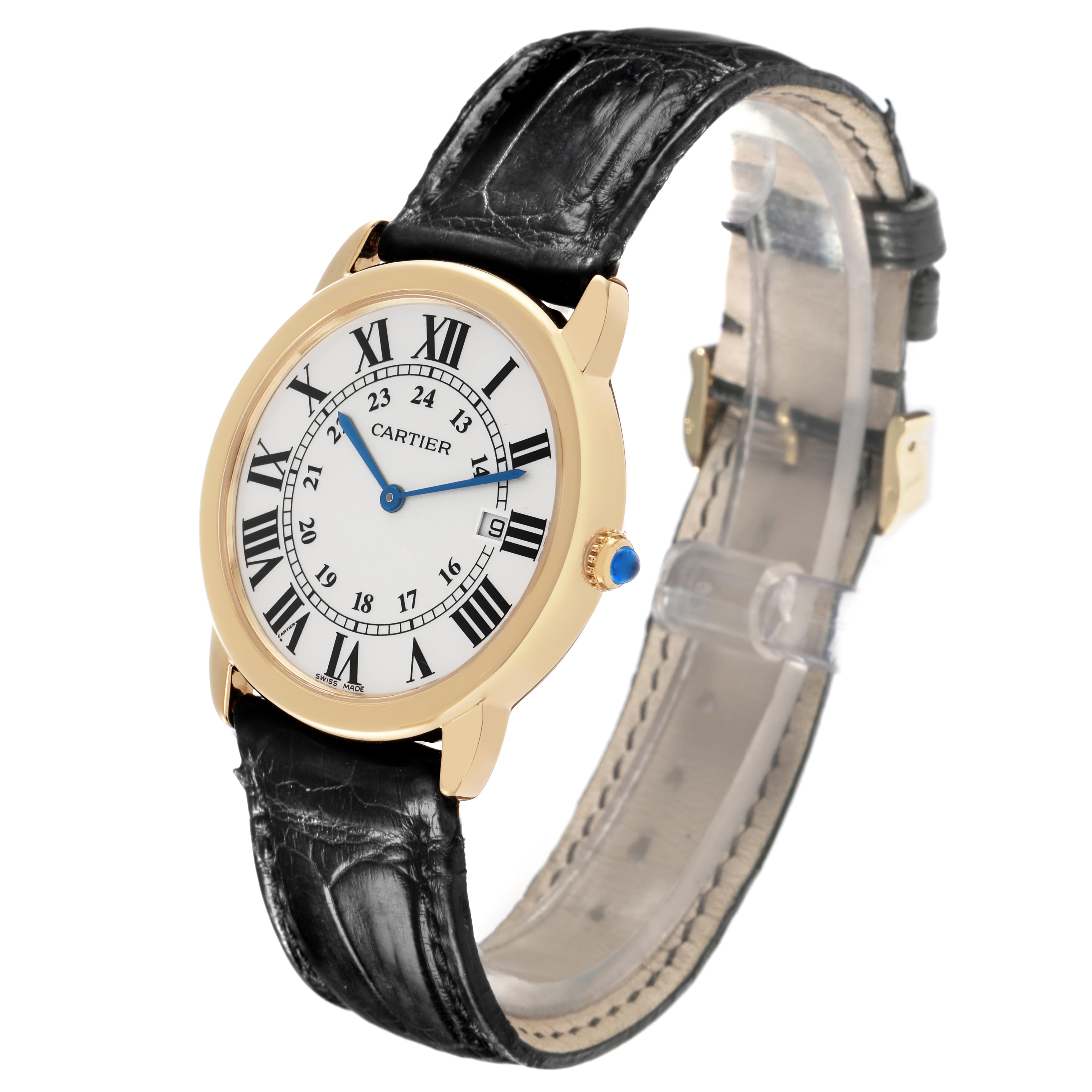 This image shows a Cartier Ronde W6700455 Men's Yellow Gold Silver Dial W6700455 Men's Yellow Gold Silver Dial watch at an angled view, displaying its face, gold casing, blue hands, and black leather strap.