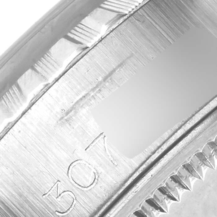 The image shows a close-up of the fluted bezel and part of the rehaut of a Rolex Date 6924 Women's Stainless Steel Silver Dial 6924 Women's Stainless Steel Silver Dial model watch.