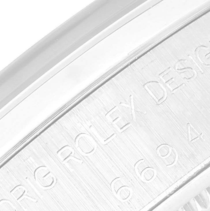 This image shows a close-up of the engraving on the side of a Rolex Date 6694 Men's Stainless Steel Blue Dial 6694 Men's Stainless Steel Blue Dial model watch case.