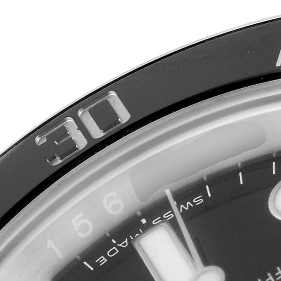 This close-up image of the Rolex Submariner 116610LN Men's Stainless Steel Black Dial 116610LN Men's Stainless Steel Black Dial watch shows part of the bezel, dial, and markers.