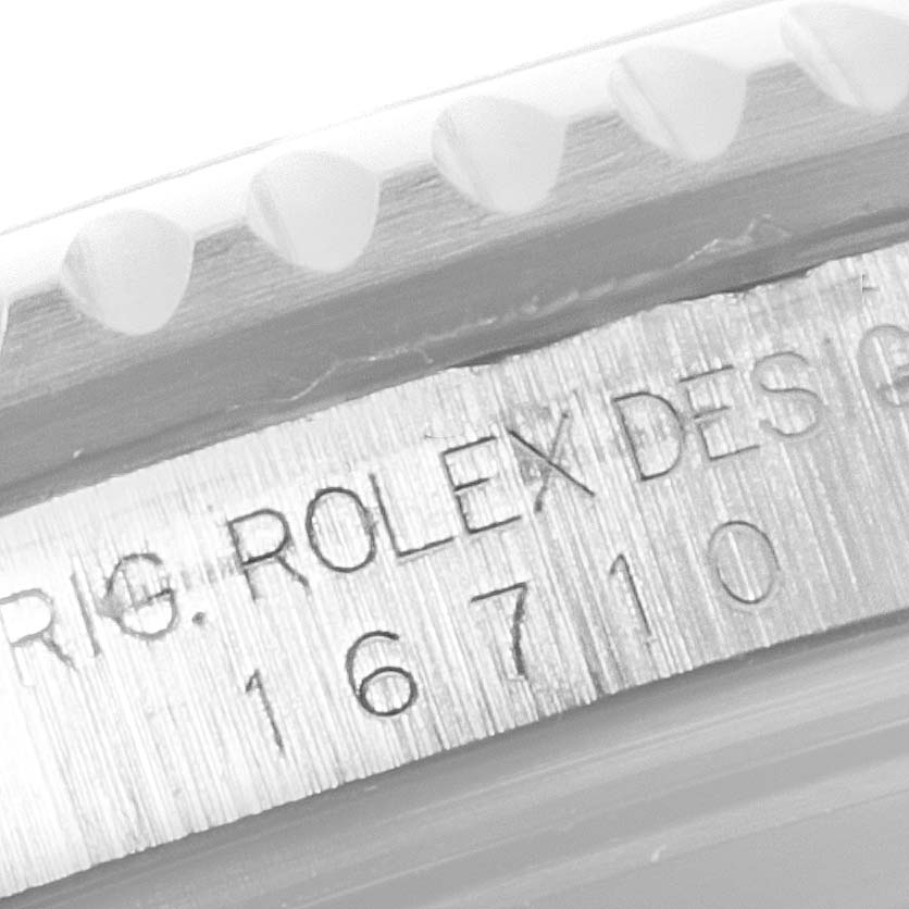 The image shows a close-up of the side of the bezel and engraved serial number of a Rolex GMT-Master 16710 Men's Stainless Steel Black Dial 16710 Men's Stainless Steel Black Dial model.