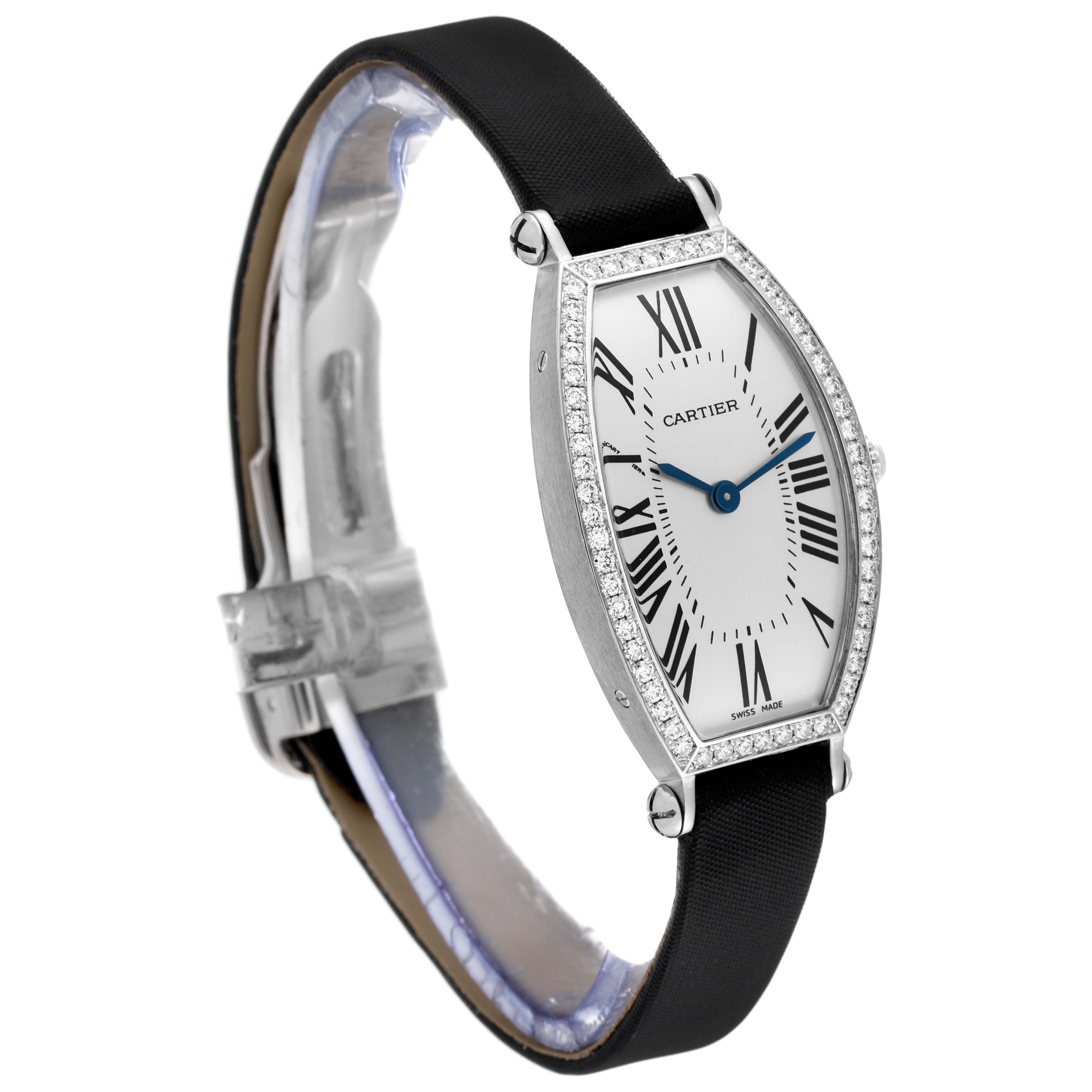The image shows a side view of the Cartier Tonneau WE400131 Women's White Gold Silver Dial WE400131 Women's White Gold Silver Dial model watch, detailing its elongated face, black strap, and diamond-set bezel.