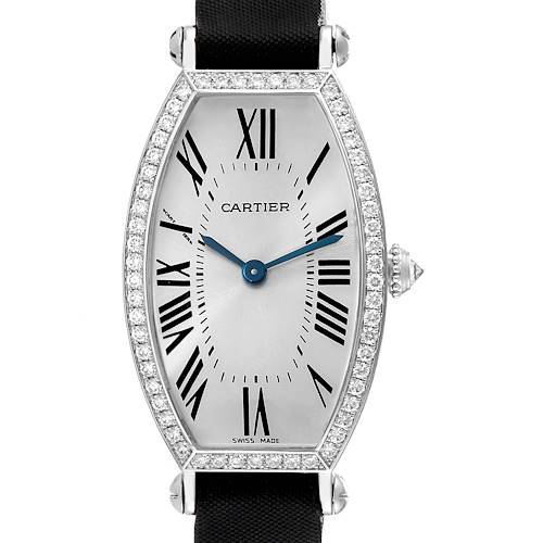 This image shows the face of the Tonneau model by Cartier, highlighting the Roman numerals, diamond detailing, and crown.