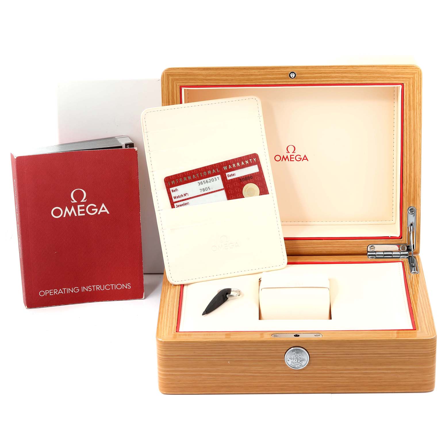The image shows the open wooden box, warranty card, and operating instructions for an Omega Speedmaster 3656.20.31 Men's Yellow Gold White Dial 3656.20.31 Men's Yellow Gold White Dial watch.