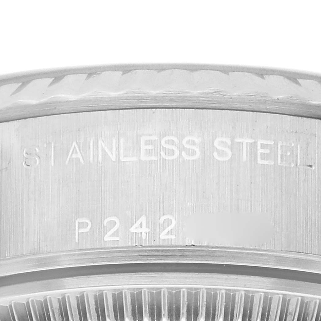 The image shows a close-up of the stainless steel casing and part of the bezel on a Rolex Datejust 79174G Women's Stainless Steel Blue Dial 79174G Women's Stainless Steel Blue Dial watch.